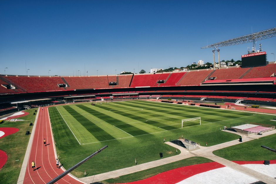Elevated view of a football stadium with empty seats and lush green field.