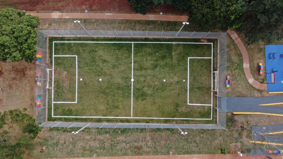 Top view of a fenced soccer field in Londrina, Brazil. Perfect symmetry and vibrant colors.