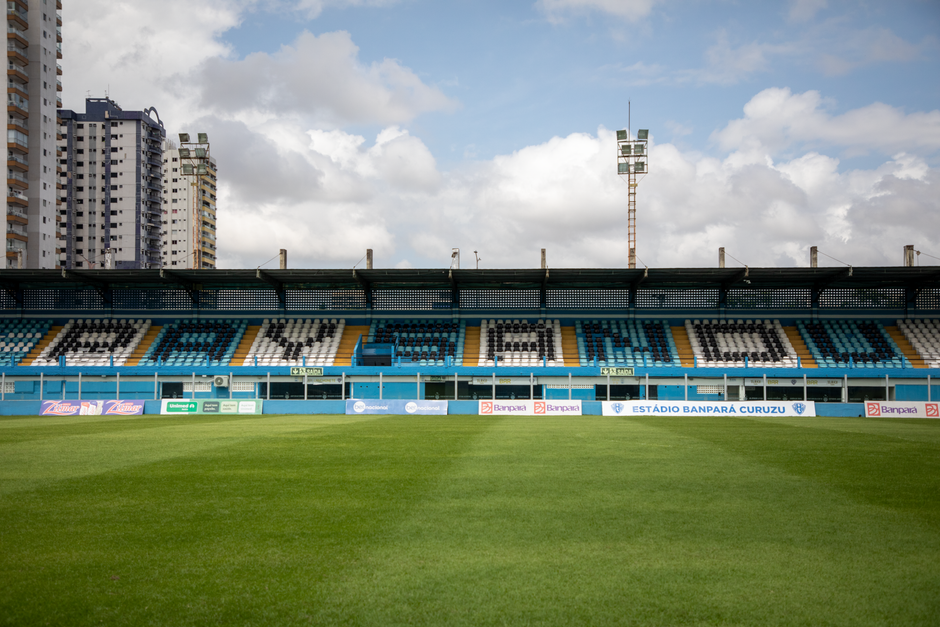 Empty Estádio Banpará Curuzu in Belém, Brazil with green grass and clear sky.