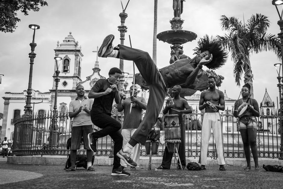 Energetic capoeira dancers showcase their skills in a lively street performance in Salvador's historic Pelourinho district.