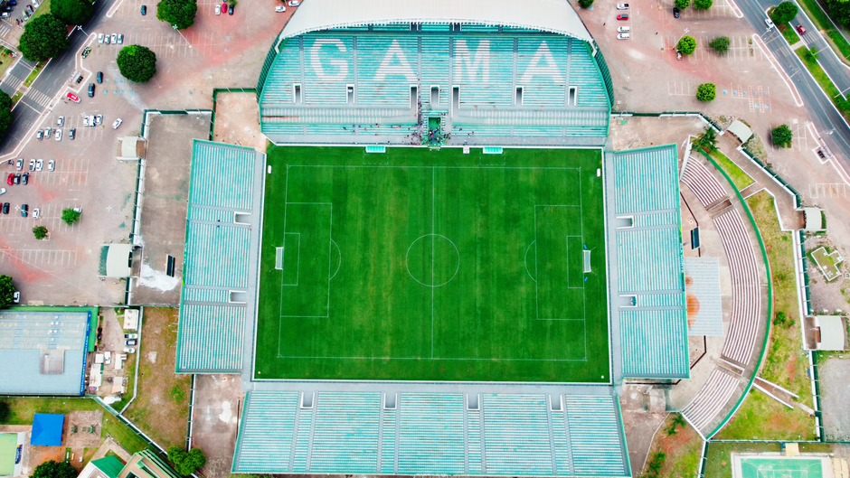 Aerial photograph of the Gama stadium in Brasília, highlighting its green field and tiered seating.