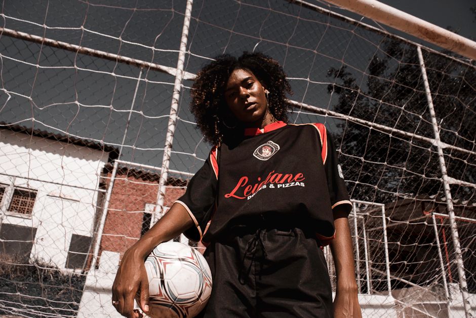 Confident young woman soccer player posing in sports outfit on a football field in Mauá, Brazil.